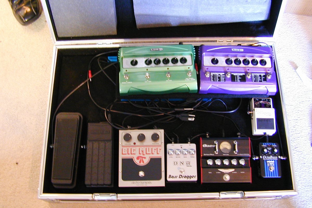 A pedalboard with multiple guitar and bass effects pedals