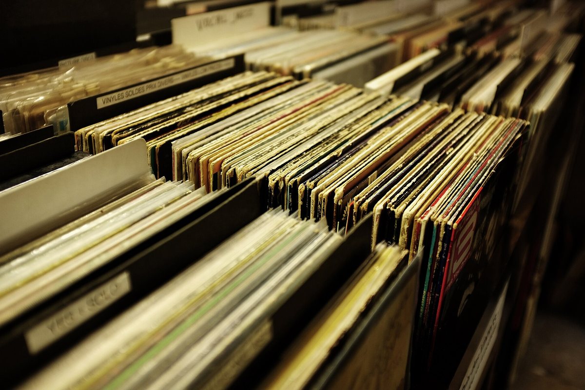 Rows of vinyl records arranged in wooden store bins