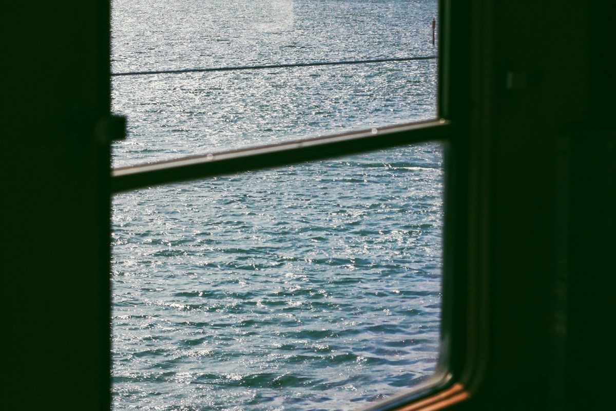 Rippling water seen through the frame of a window