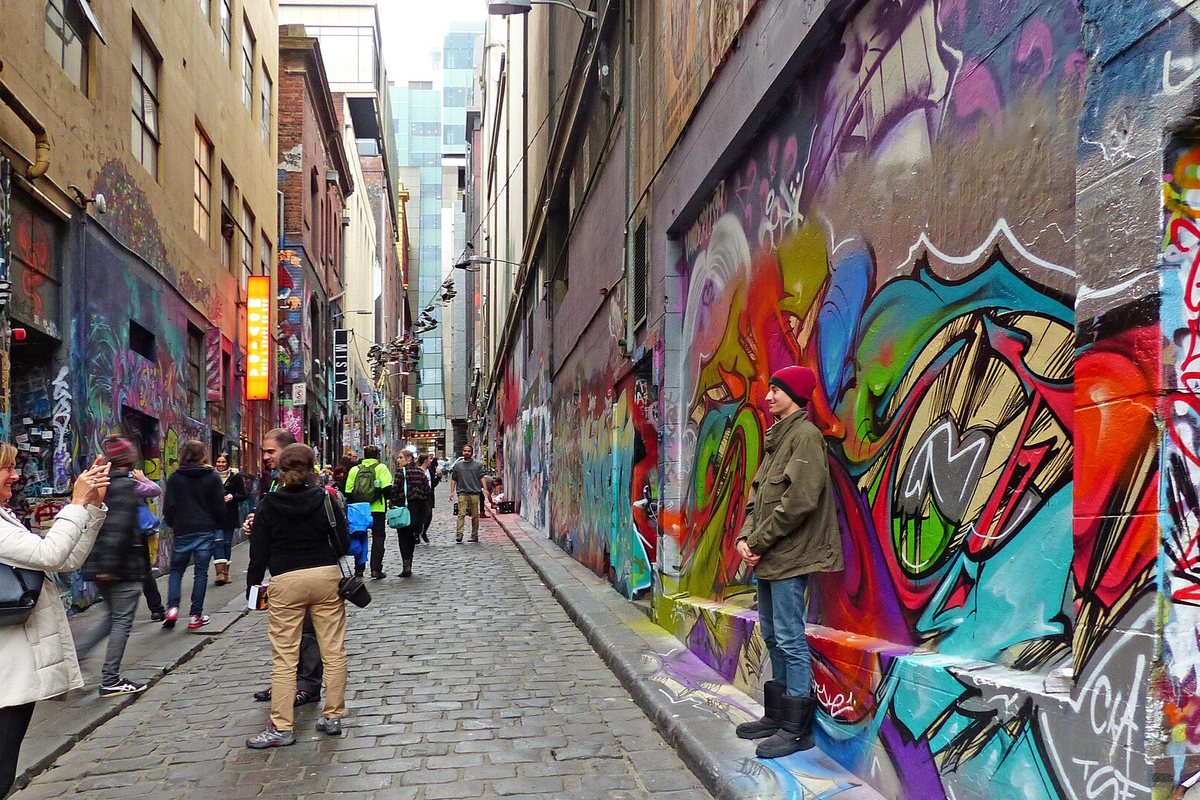 People walk through the colorful street art of Hosier Lane in Melbourne