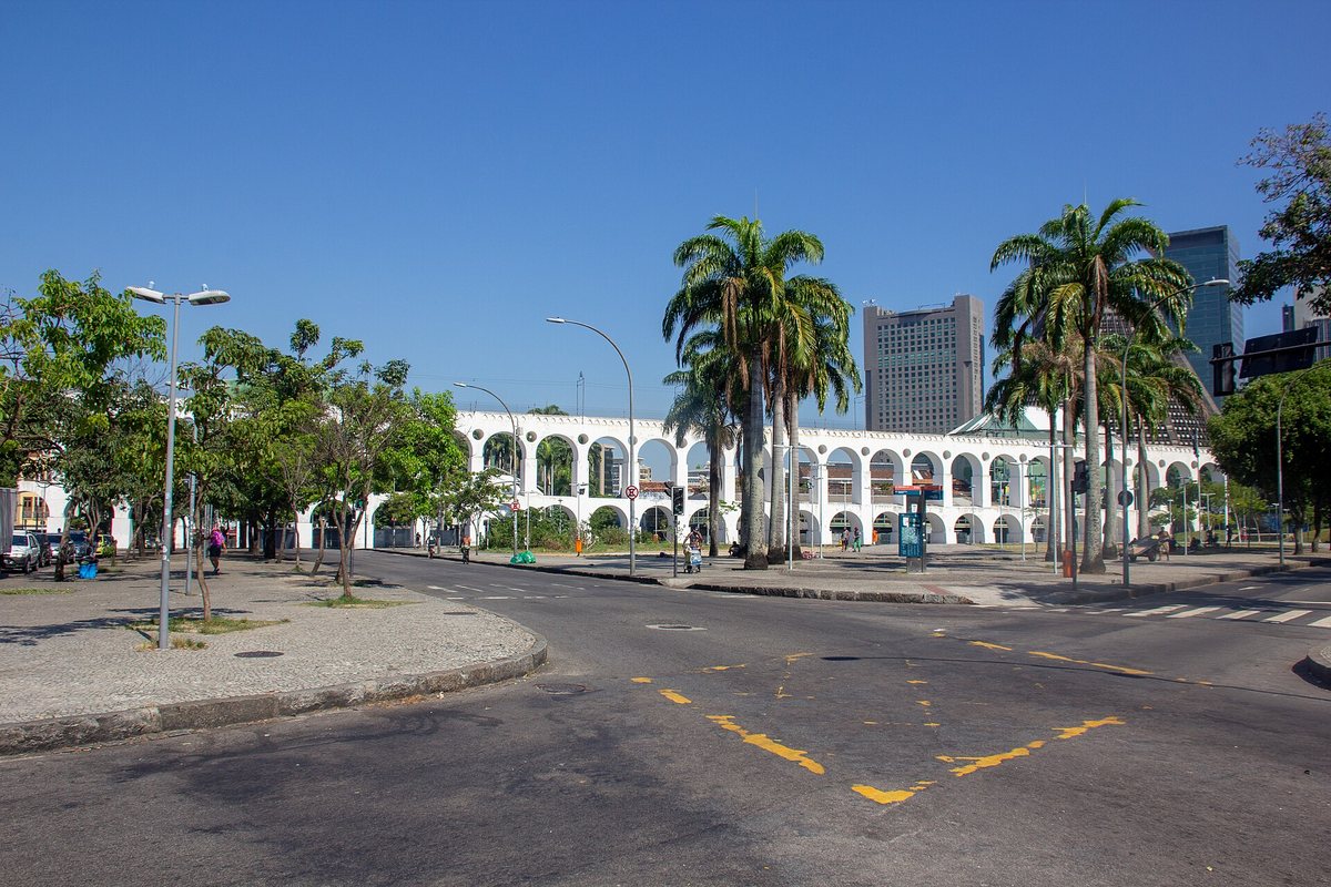 Palm trees and the white arches of the Carioca Aqueduct in Rio de Janeiro
